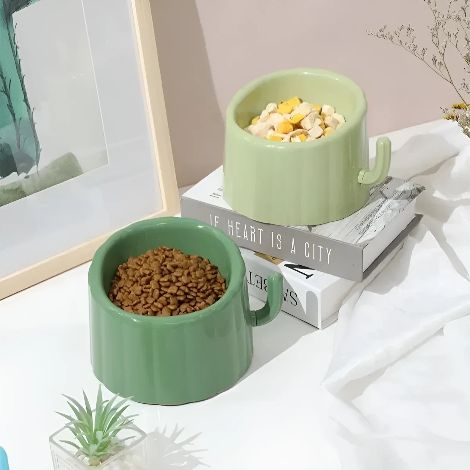 Solid green cat bowl with cactus pattern and anti-slip base on a kitchen floor.