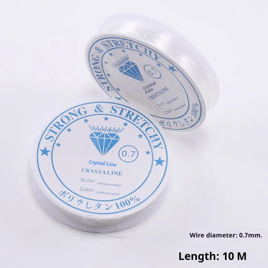 A reel of transparent white elastic cord for jewellery making, showing its fine diameter and crystal-clear finish.