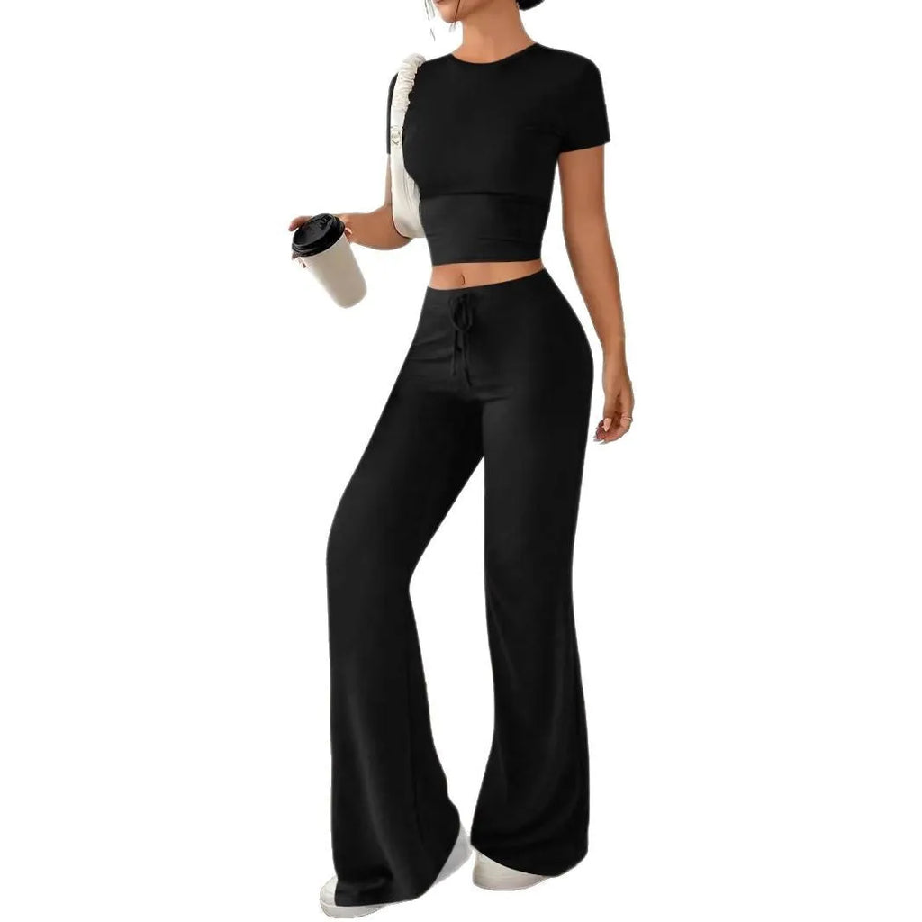 Black women's polyester trousers suit with high-waist trousers and a short-sleeve T-shirt on a hanger.