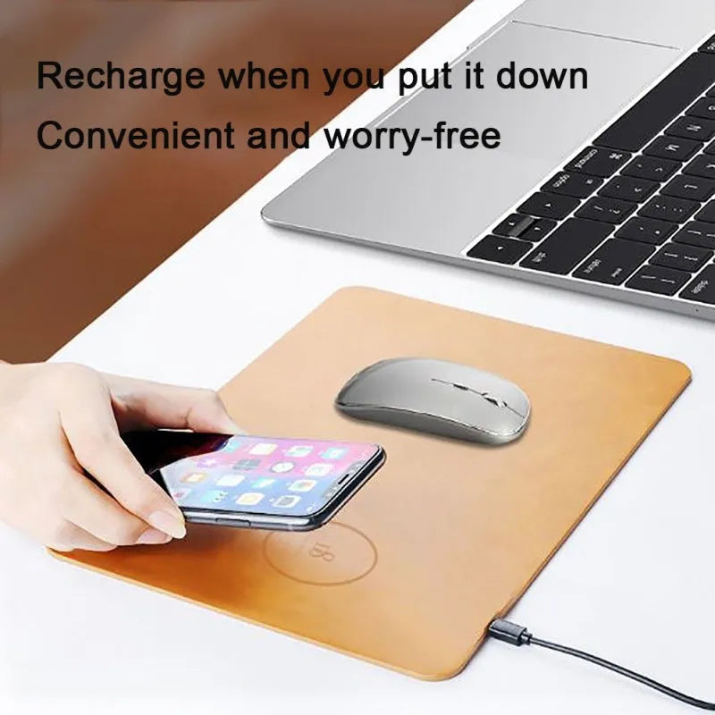 Brown leather desk mat with integrated wireless charging pad for mobile phones on a wooden desk.