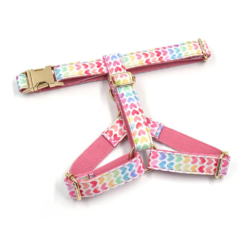 Pink dog harness with gold buckle and colourful heart-shaped stone decoration in four sizes