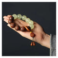 Wooden bracelet with carved Amass Fortunes character on rosewood segments