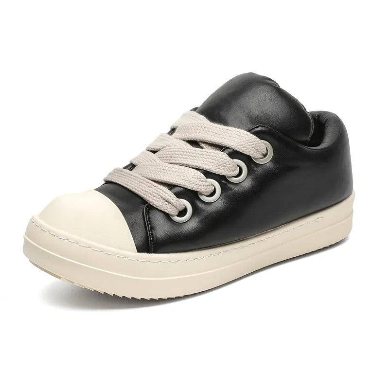 Men's black slip-on casual shoes with raised sole, leather uppers, and rubber soles showing round toe and shallow cut design