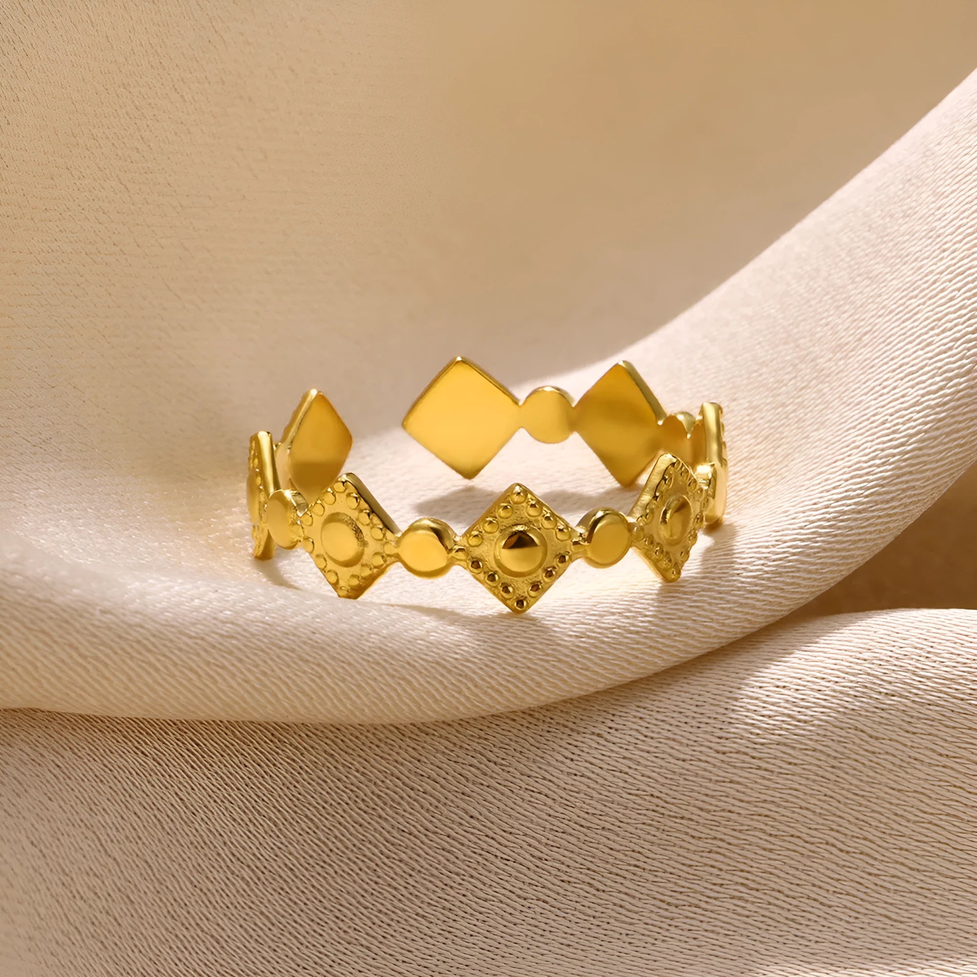 Geometric gold titanium steel ring for women on a white background.