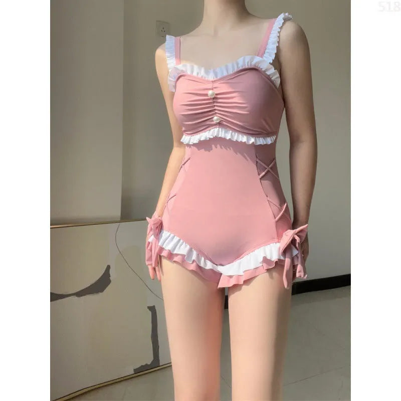 Women's solid colour one-piece swimsuit in milk silk fabric, shown in pink.