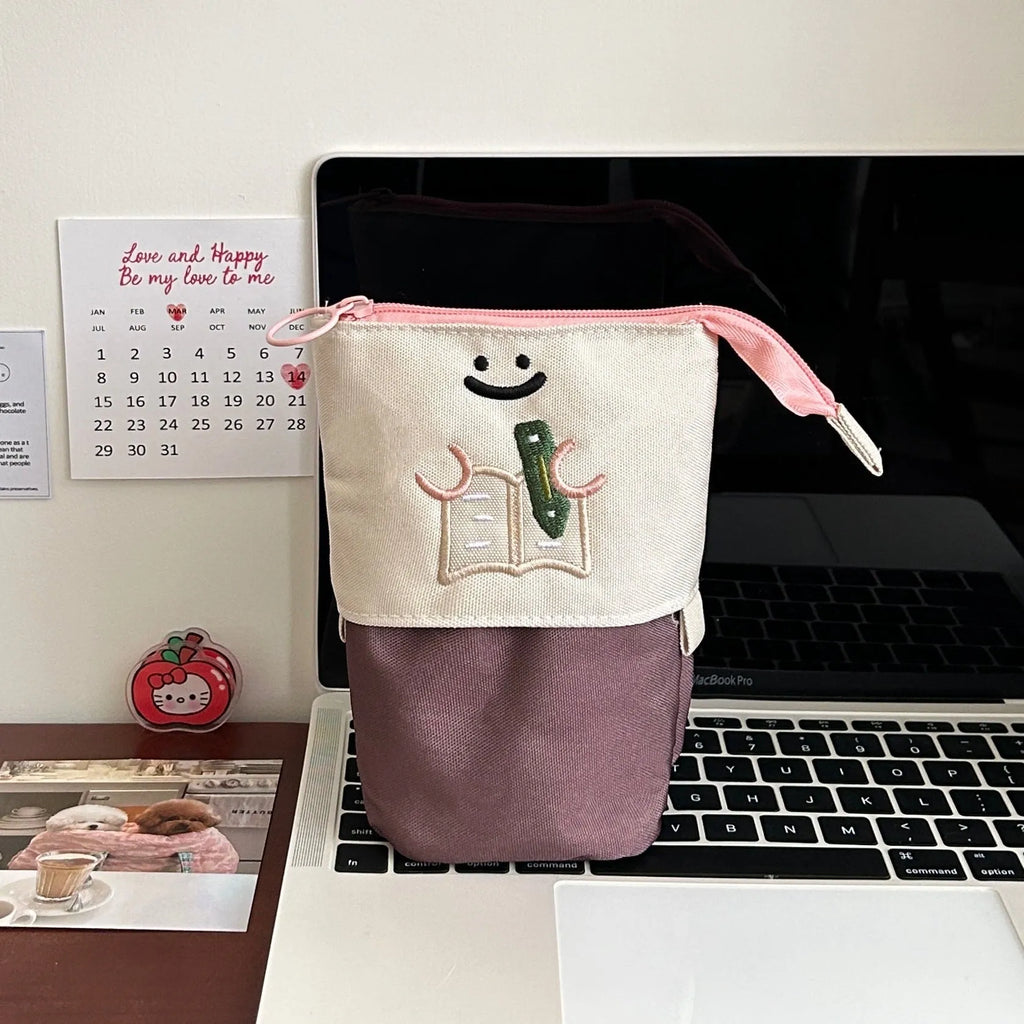 Brown collapsible pencil case with cartoon design, shown open and closed