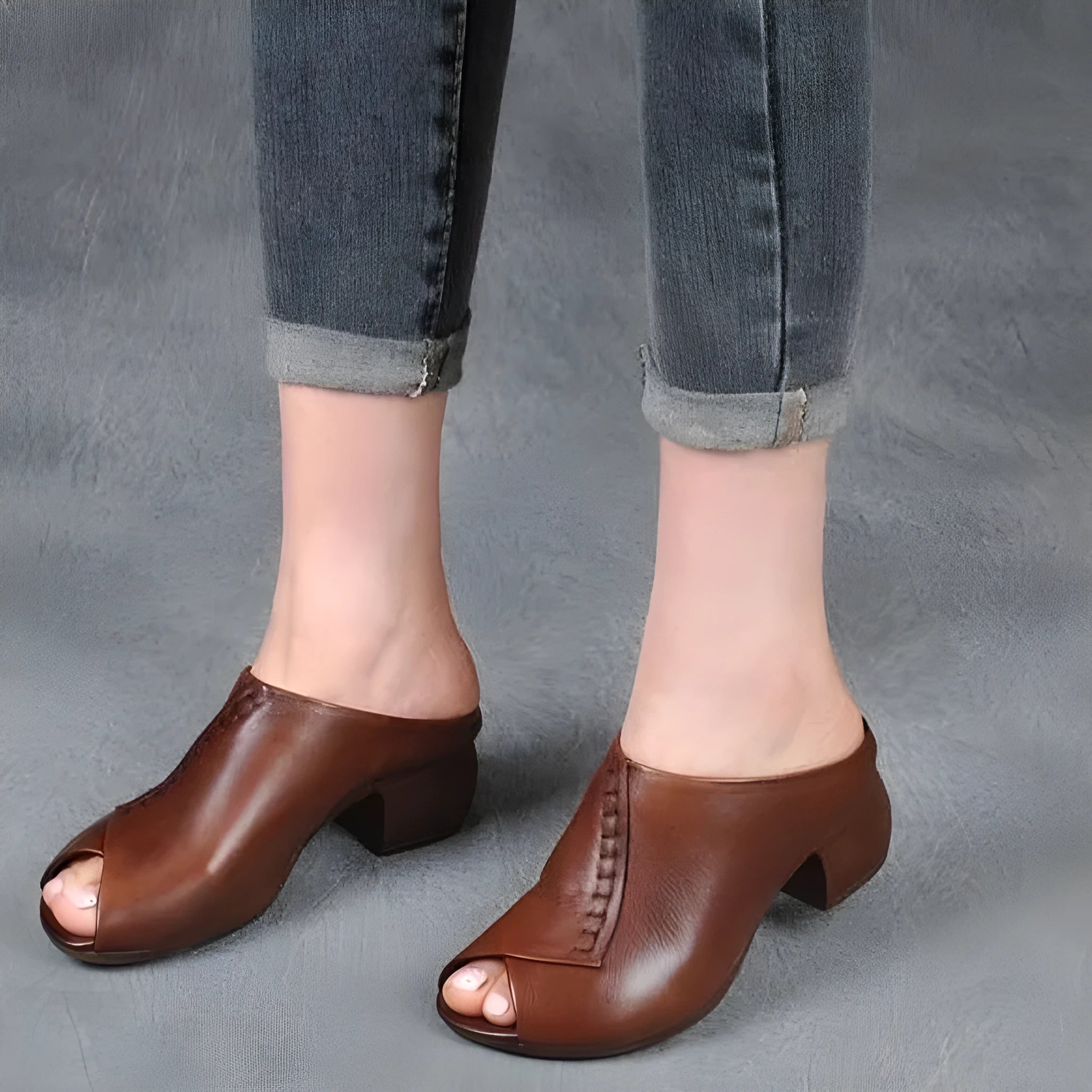 Women's black square heel peep-toe slippers with a fish mouth scaffold design on a rubber sole.