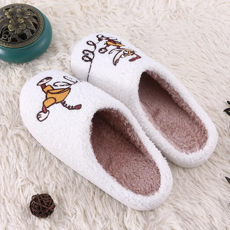 White adult fluffy slippers with cartoon pattern, rubber sole, and plush upper.