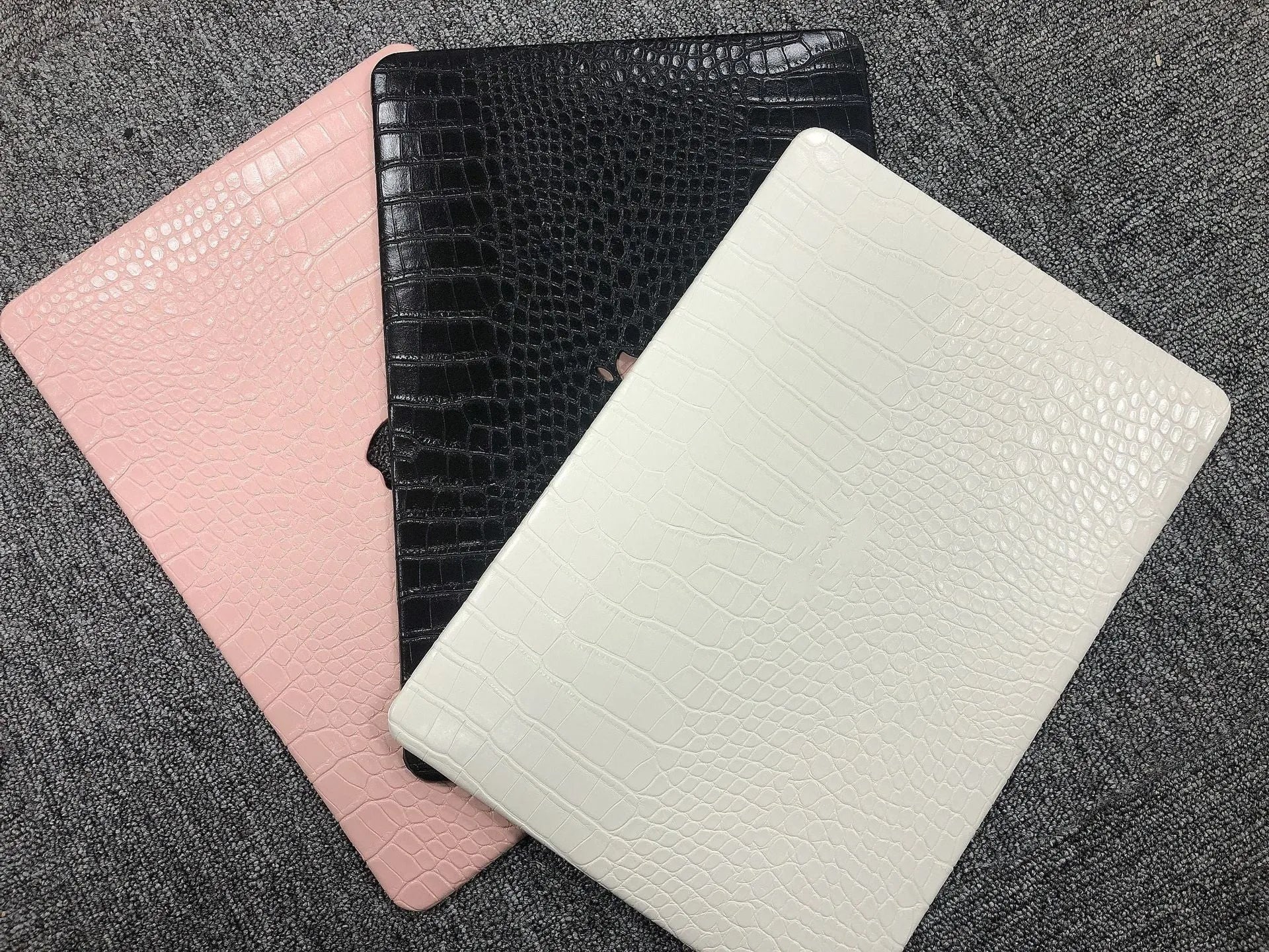 MacBook protective case with crocodile pattern texture and hollowed-out Apple logo in soft pink colour