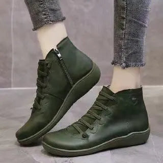 Women's casual flat ankle boots in artificial PU leather with a round toe and wedge rubber sole.