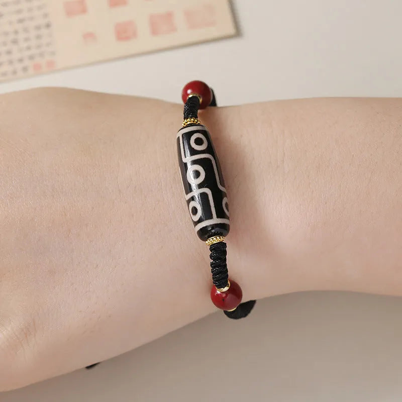 Men's shrinkable agate bracelet with Tibetan Dzi bead patterns on a wrist