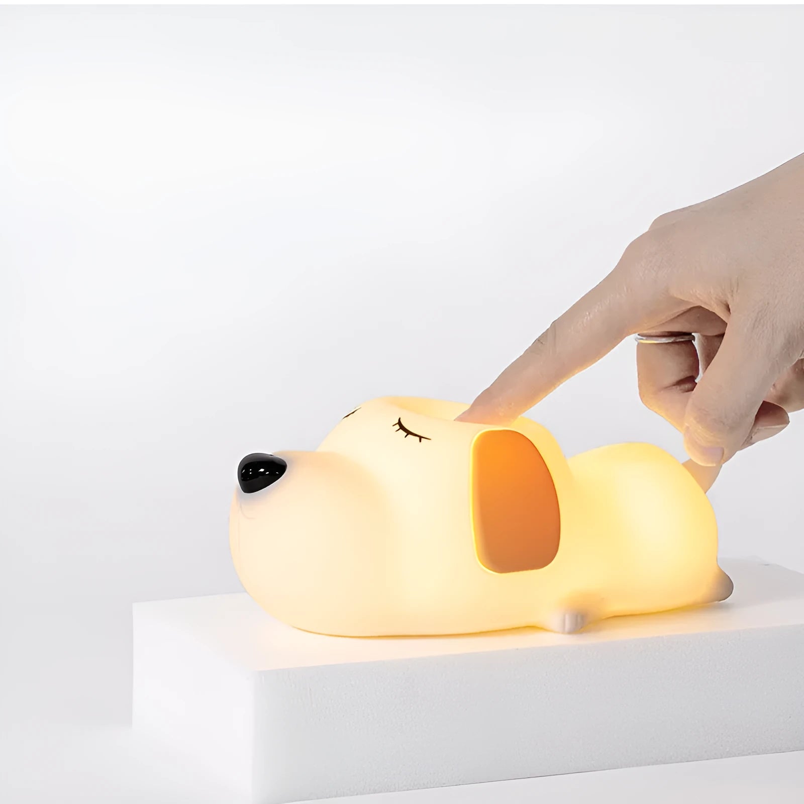 Silicone cartoon dog night light with two colours and a USB cable.