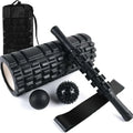 Black 33cm long foam roller massage stick with gear bar design on a grey background.