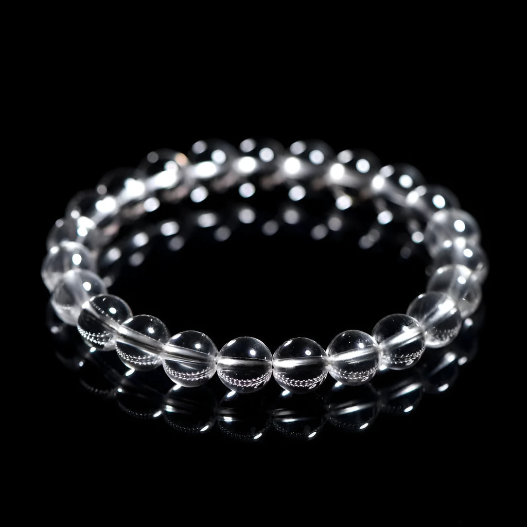 Natural white crystal bead bracelet with geometric design on a wrist.