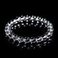 Natural white crystal bead bracelet with geometric design on a wrist.