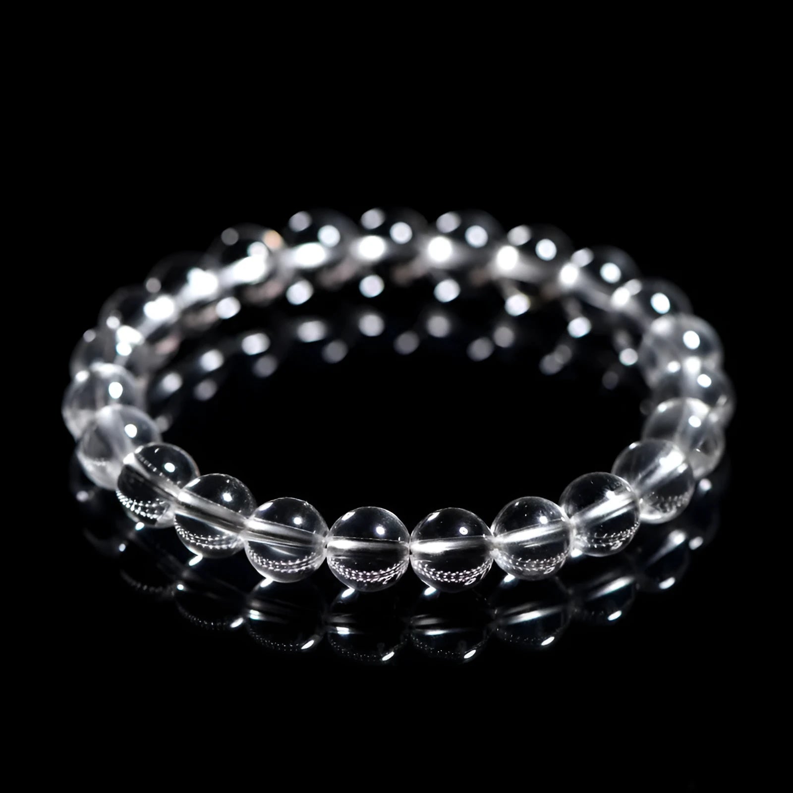Natural white crystal bead bracelet with geometric design on a wrist.