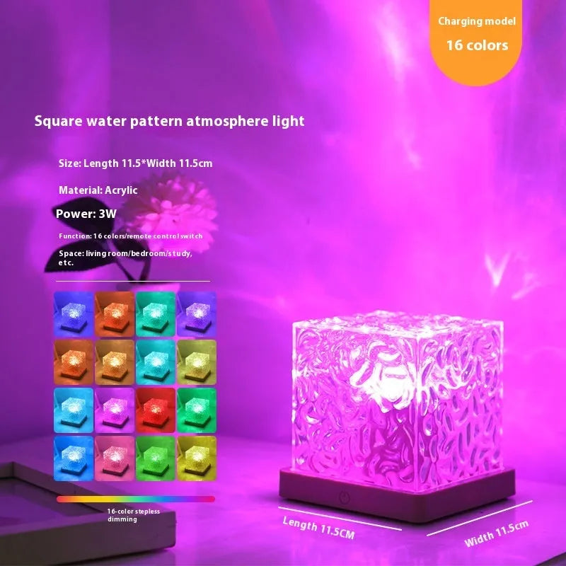 LED crystal table lamp projecting blue water ripple light effect on wall.