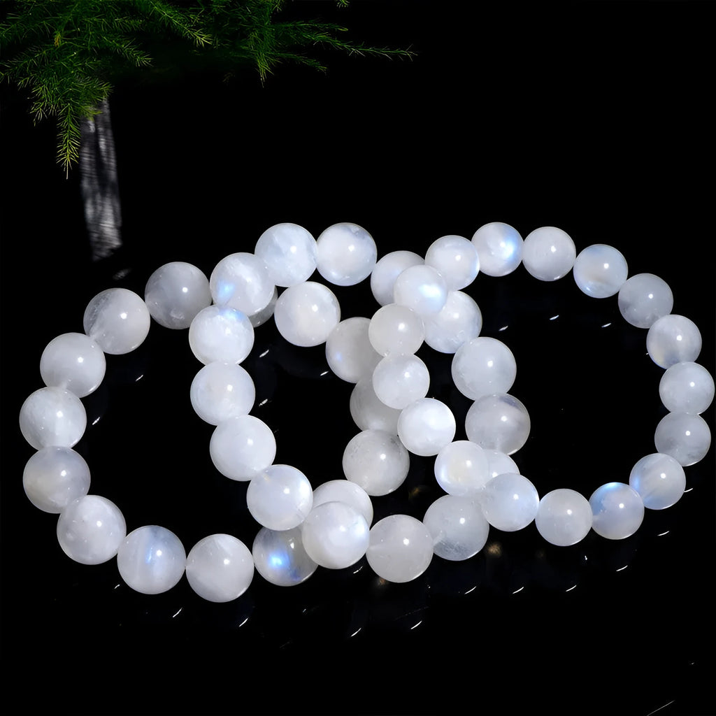 Natural white Blue Moonlight Moonstone round bead bracelet on wrist, showing polished gemstone beads.