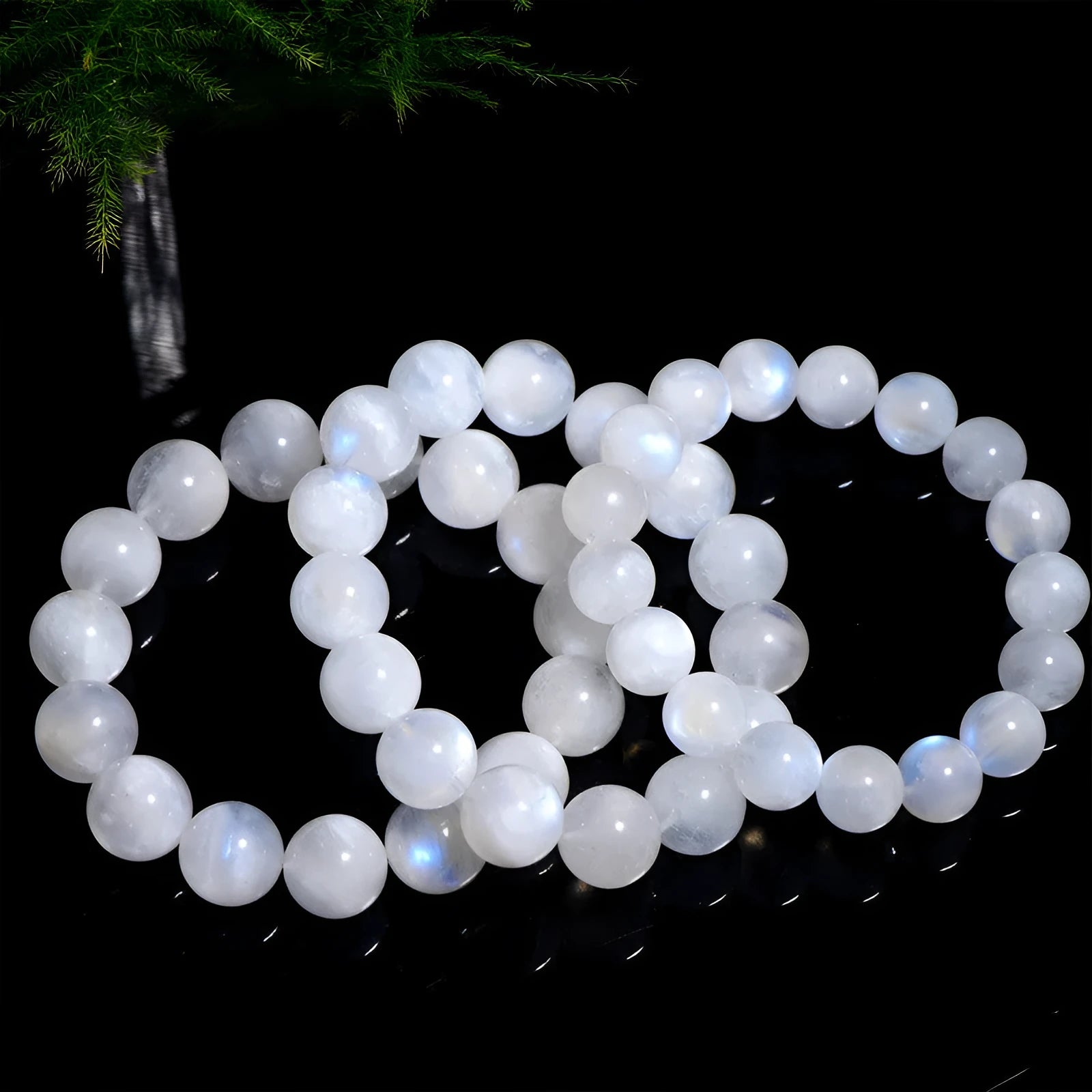 Natural white Blue Moonlight Moonstone round bead bracelet on wrist, showing polished gemstone beads.