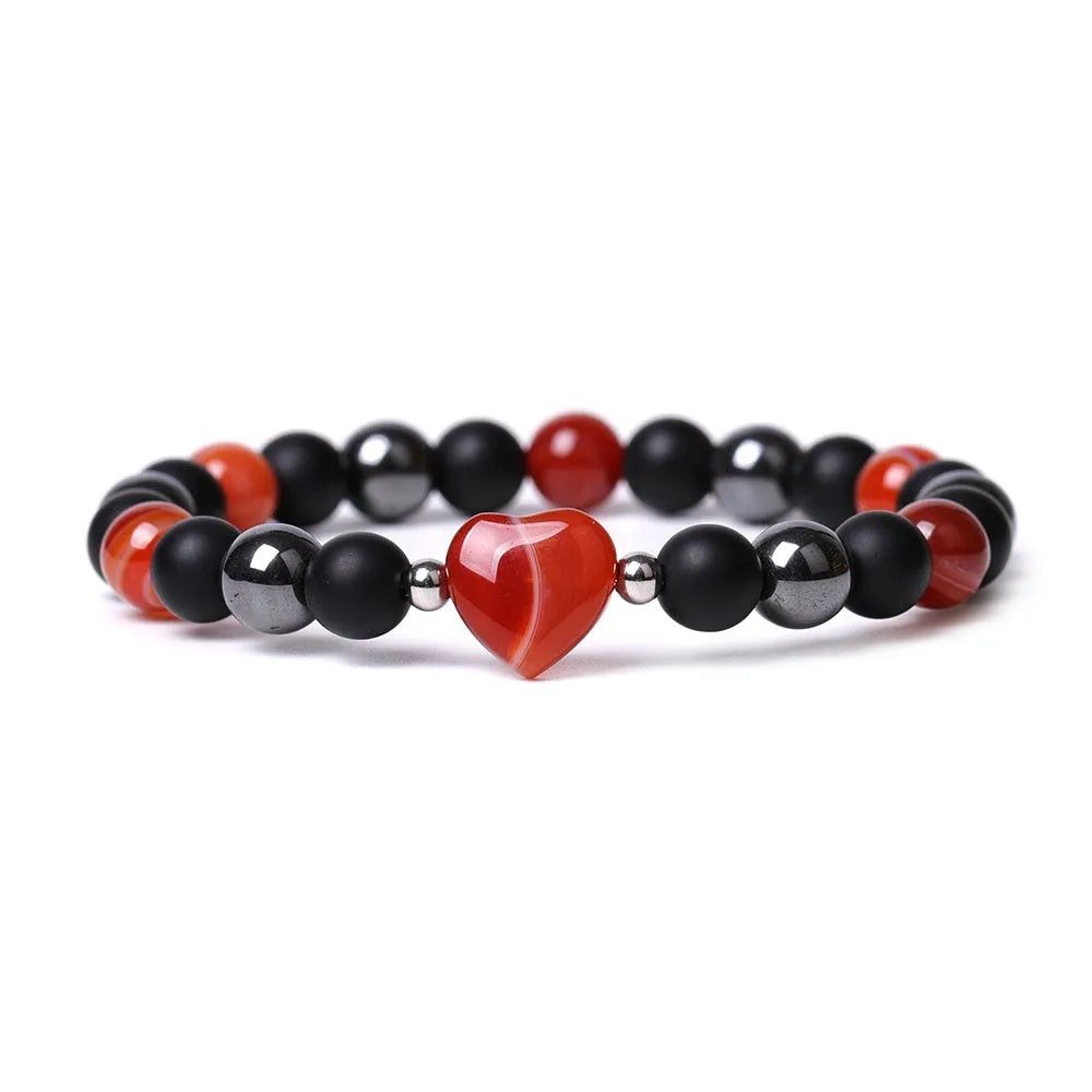 Hand-cut peach heart stone bracelet in geometric design with planetary elements