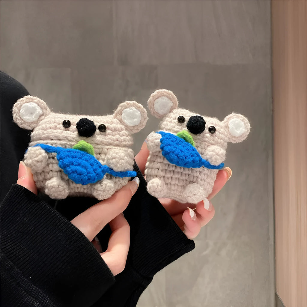 Handmade knitted koala bear backpack-shaped cover for an AirPods charging case.