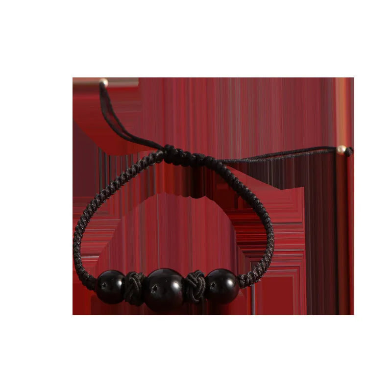 Woven red rope bracelet with strawberry quartz sphere beads and alloy detailing