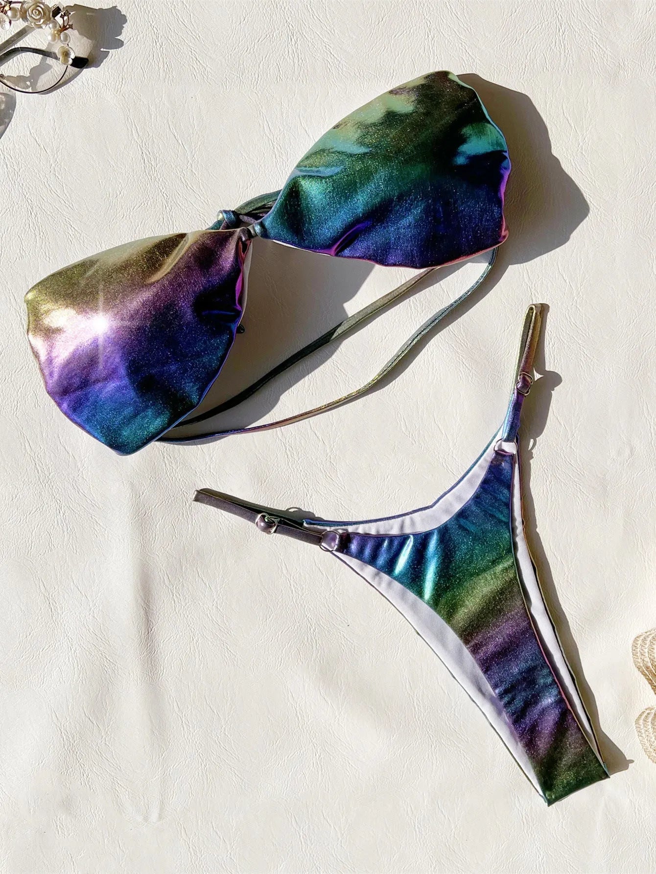 Women's purple gradient bikini swimsuit on a mannequin, showing front and back views.