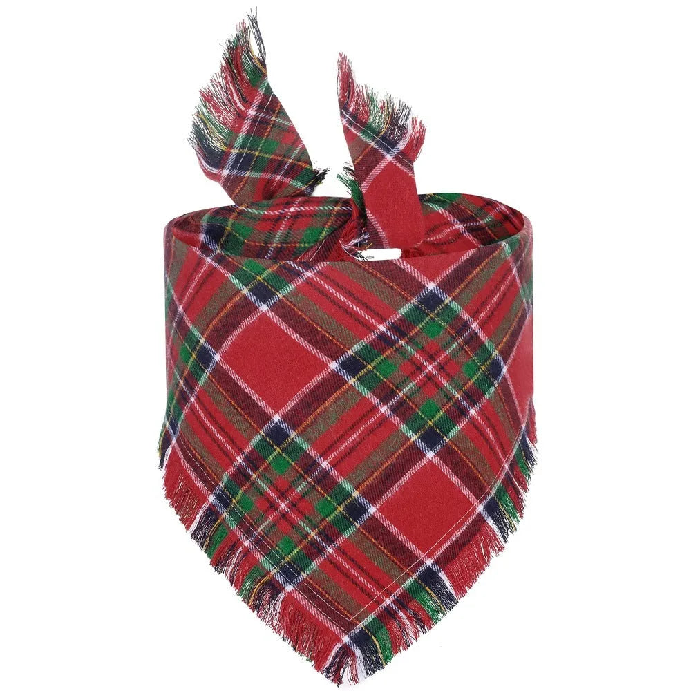 Plaid triangle dog bandana with tassel edges in autumn colours like brown, green, and orange.