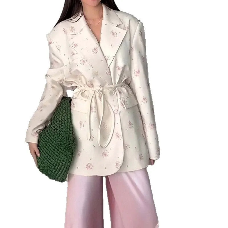 Women's printed polyester jacket with a lace-up collar detail, shown in a floral design.