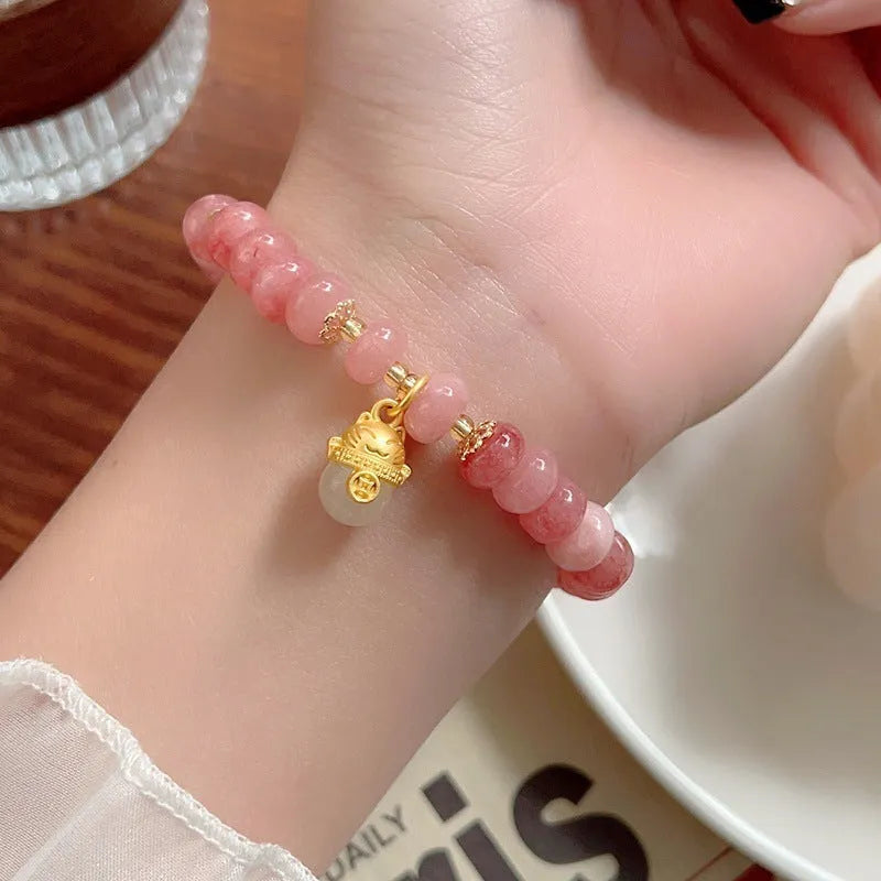 Women's strawberry quartz bracelet with lucky cat charm and animal zodiac modelling in retro style