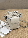 Cortex women's genuine leather bucket crossbody bag in black with drawstring closure and patchwork design, 15 x 20 x 12 cm