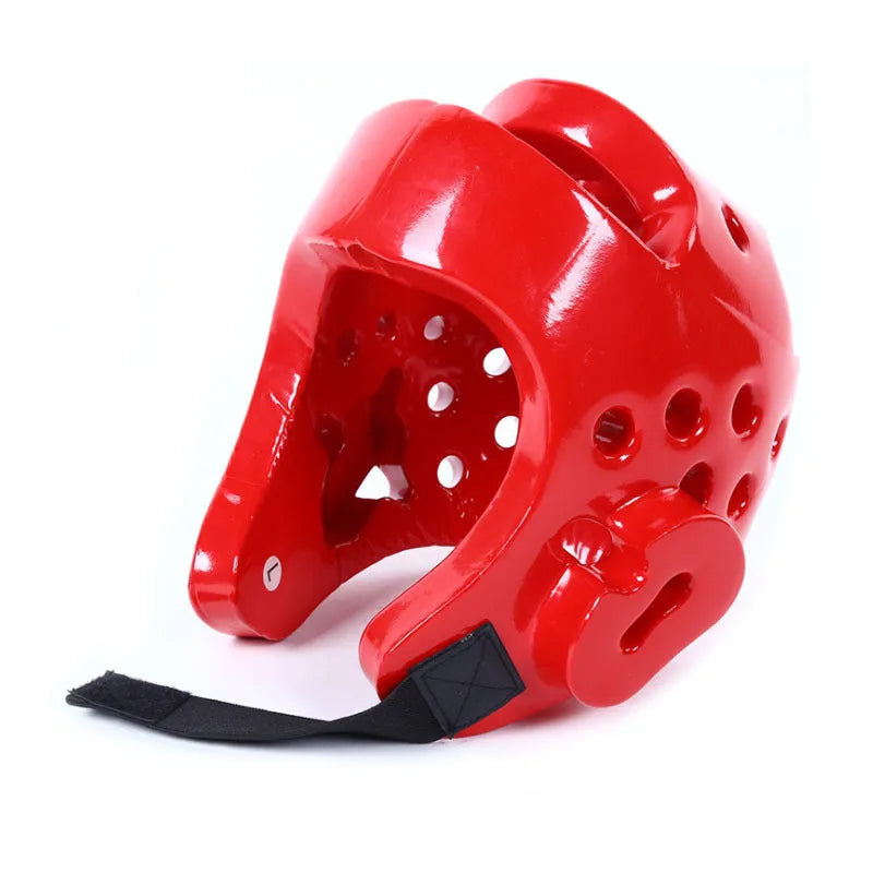 Red and blue karate protective gear set with helmet, boxing gloves and leg guards on training mat