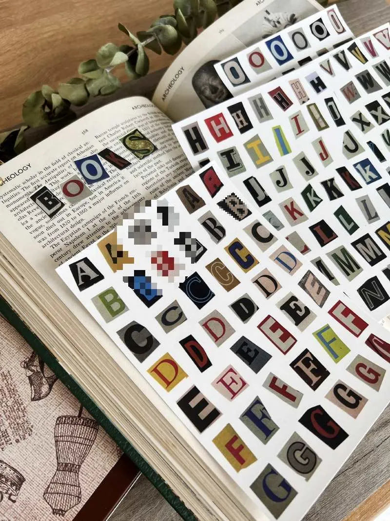 Set of decorative stickers showing English letters, numbers, and weekly words in a cute printed style.