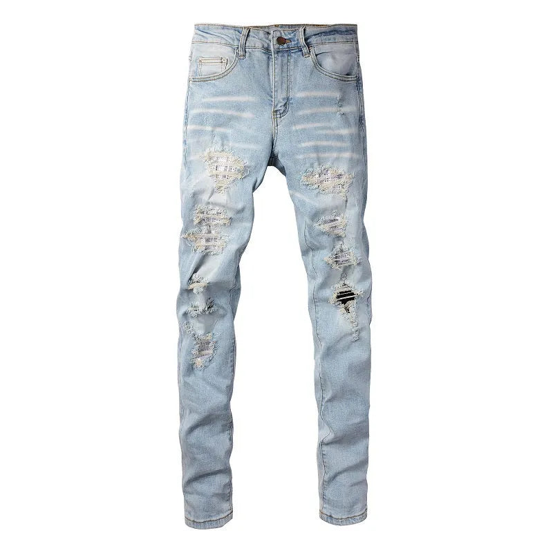 Light blue slim fit men's jeans with patch details, holes, and enzyme-washed finish