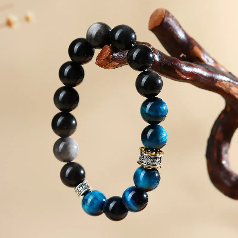 Peacock blue Tigereye stone bracelet with geometric ethnic design on wrist