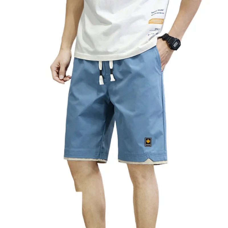 Casual loose straight-leg beach shorts on a plain background, shown in a green colour variant.