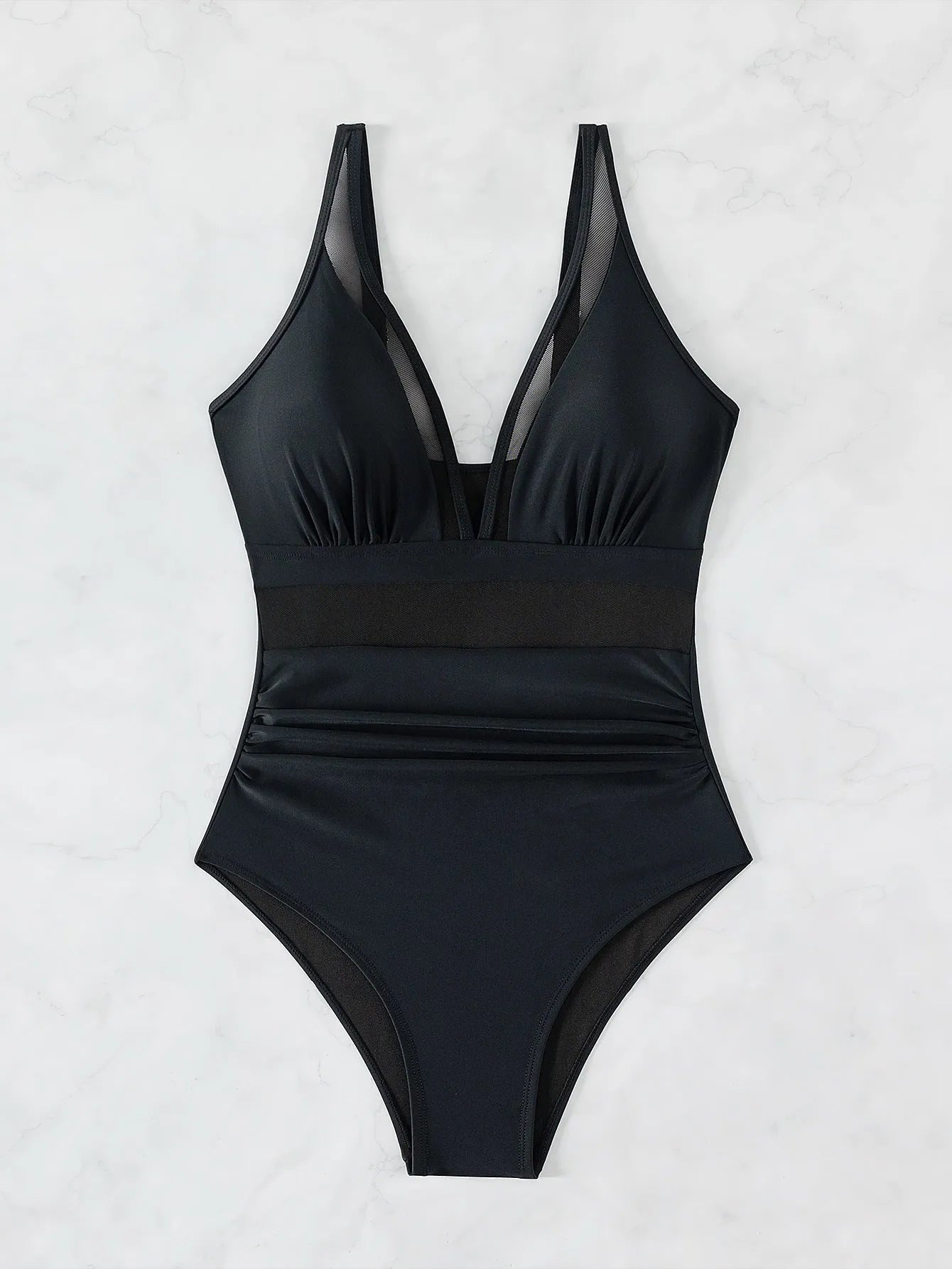 Black women's halter-neck one-piece swimsuit with mesh colour-block panels on mannequin.