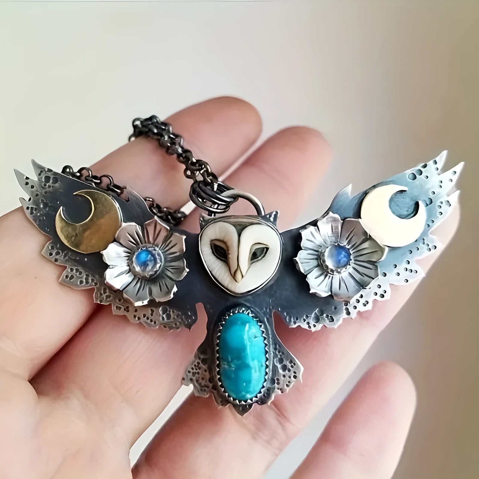 Silver electroplated alloy necklace with owl, moon, and flower pendant on unisex chain