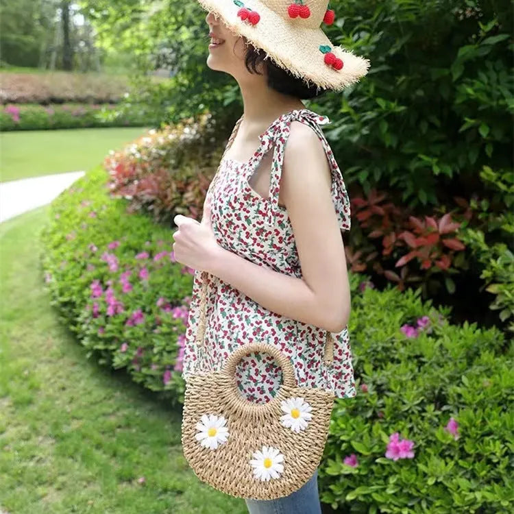 Women's woven straw crossbody bag with daisy pattern in light brown colour