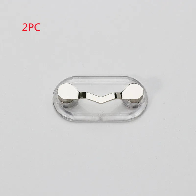 Magnetic glasses holder in black for travel storage of sunglasses on a metal surface
