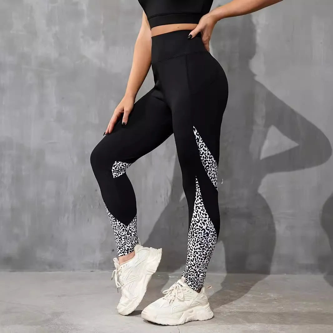 Black women's high-waist fitness leggings with colour-contrast patchwork patterns and side pockets.