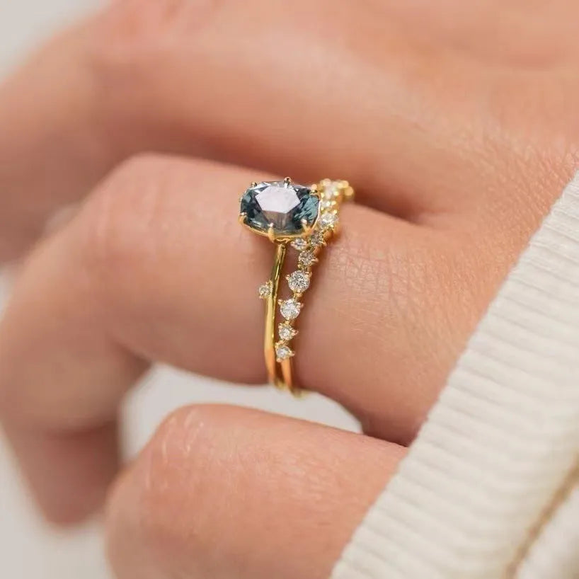 Gold-plated women's ring with green zircon stone in floral design on finger