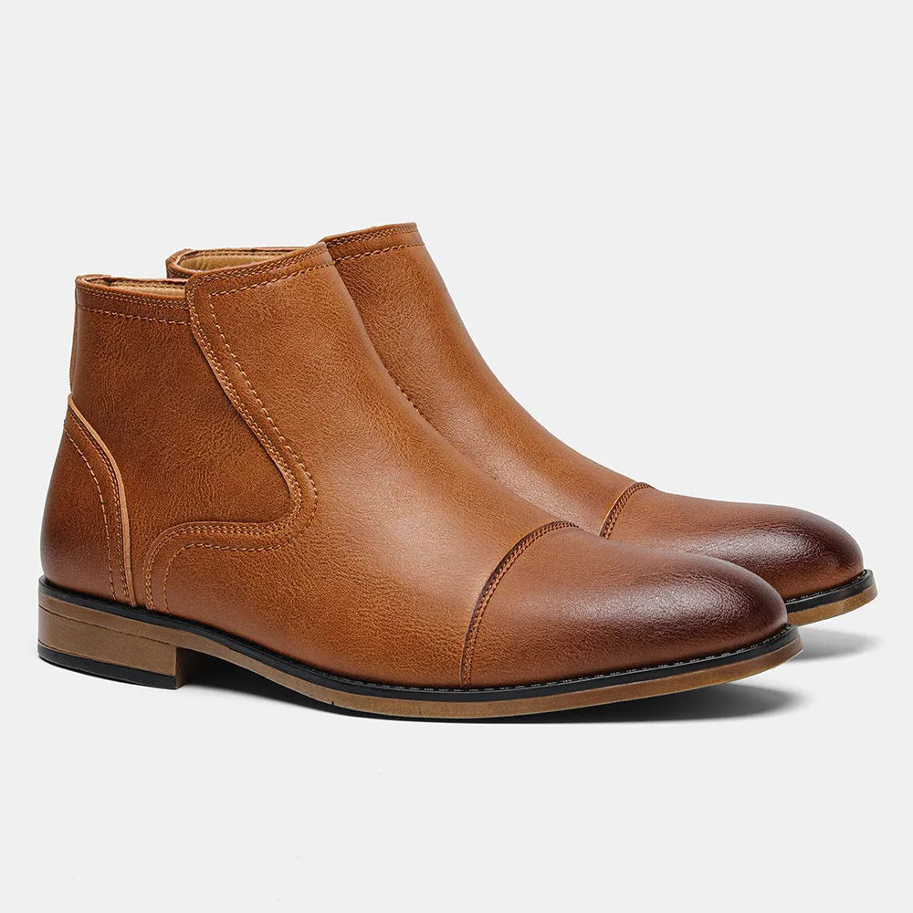 Men's brown Chelsea boot with a side zipper, round toe, and low wooden sole.