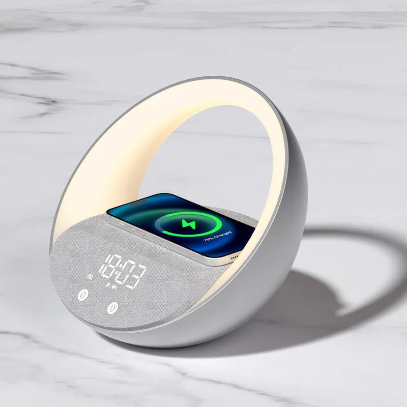 Beige multifunctional wireless charging Bluetooth speaker with clock and adjustable LED mood lighting on a wooden table.