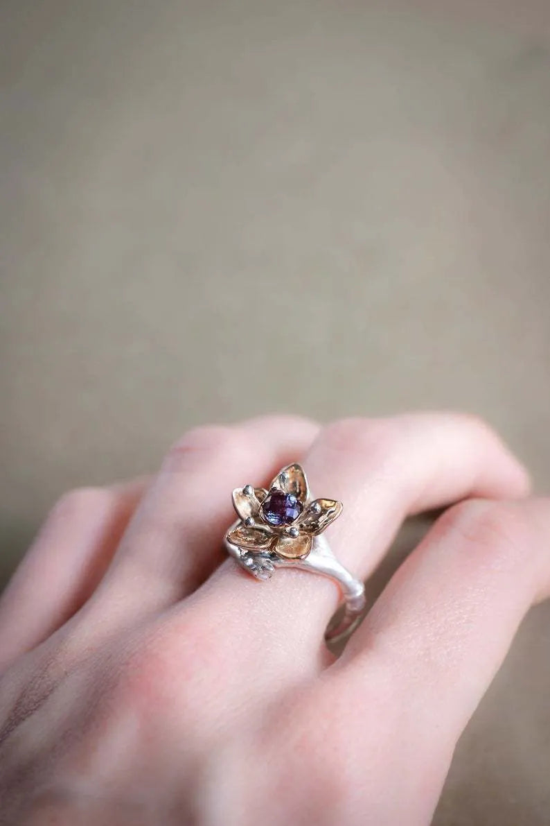 Silver two-tone women's ring with floral and geometric design on an alloy band.