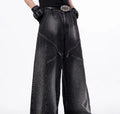 Black and grey washed wide leg cotton denim trousers and matching waistcoat set laid flat.