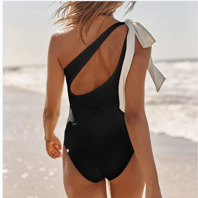 Solid colour one-piece swimsuit with backless design, sleeveless cut, polyester, Rose Red or Black, sizes S to L.