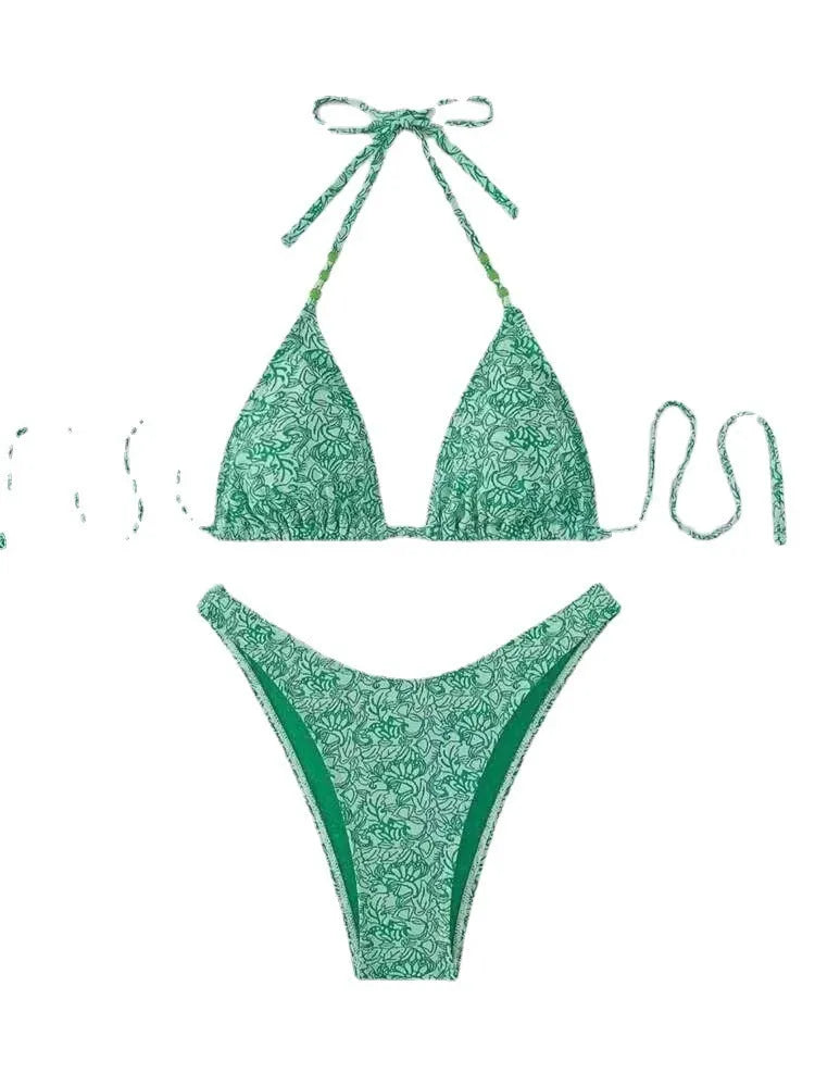 Women's flower pattern halter bikini top and shorts set in emerald green.