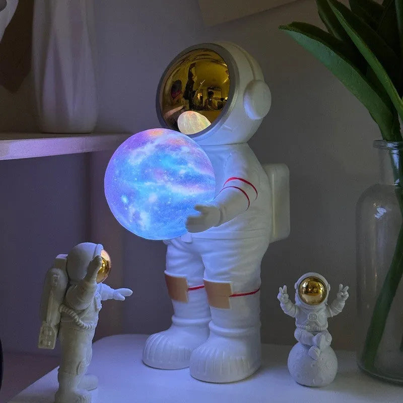 Spaceman starry sky projection lamp showing six-colour LED lighting on dark surface