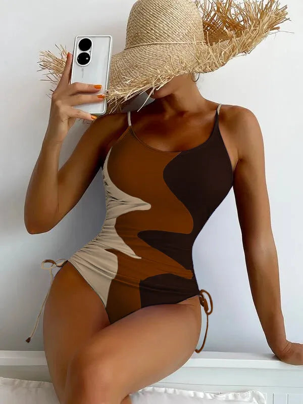 Women's sleeveless backless one-piece swimsuit in blue, purple, brown, or green.